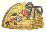 yellow tunisian stitch tea cozy with flowers and a bow