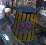 Small tin jug with vertical yellow stripes and flower motif