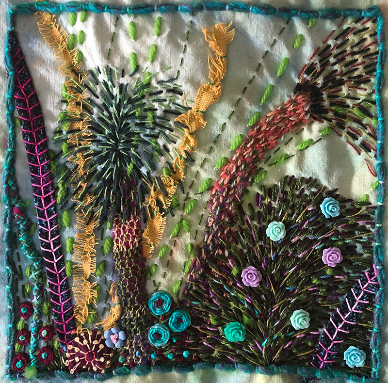 Embroidered sampler with layered stitching.