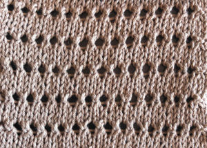 A swatch of knitted pineapple stitch.