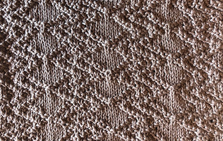 Diamond and zig-zag swatch in knit/purl stitches.