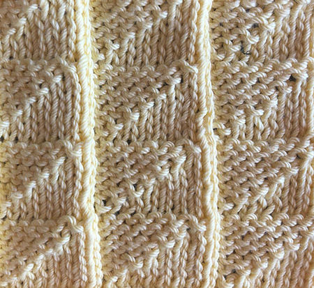 A triangular knit and purl stitch swatch.