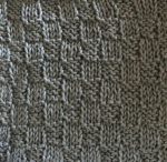 Knit/purl swatch with small checks.