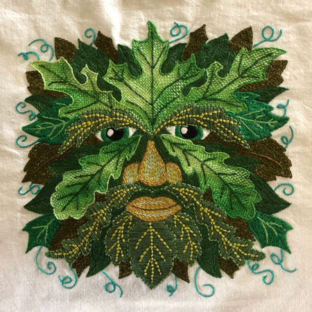 Green man embroidered sampler