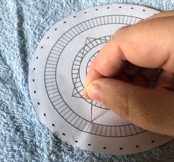 Making the holes in a paper pin template