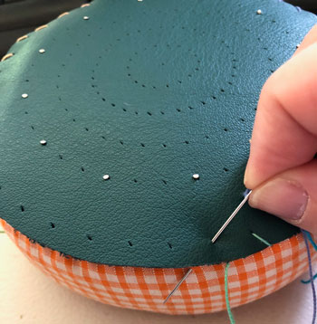 Sewing the pin template onto the pillow.