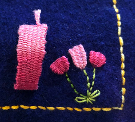 Various woven embroidery stitches on a background of dyed woollen blanket.