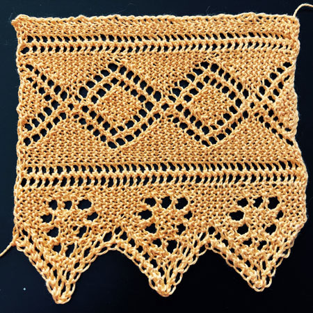 Knitted lace border with eyelet pattern of double diamonds and pennant flags