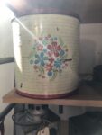 A vintage flour tin with flowers