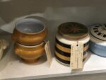 Vintage and retro pottery with bold striped design in chocolate and golden yellow.