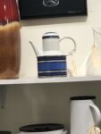 Blue and white striped tea or coffee pot with a circular handle